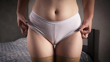 A mature female in stockings taunts with her milky underpants revealing a cameltoe and hip gap up close